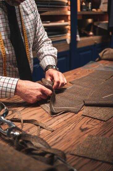 a tailor working on a custom suit