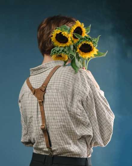 Boy Holding Sunflowers and Wearing Suspenders