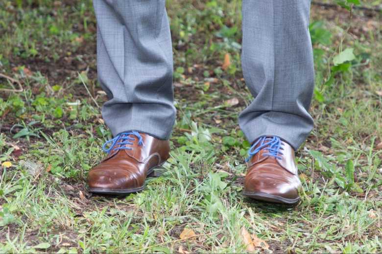 Close-up of Grey Sit Pants with Brown Shoes and Blue Shoelaces