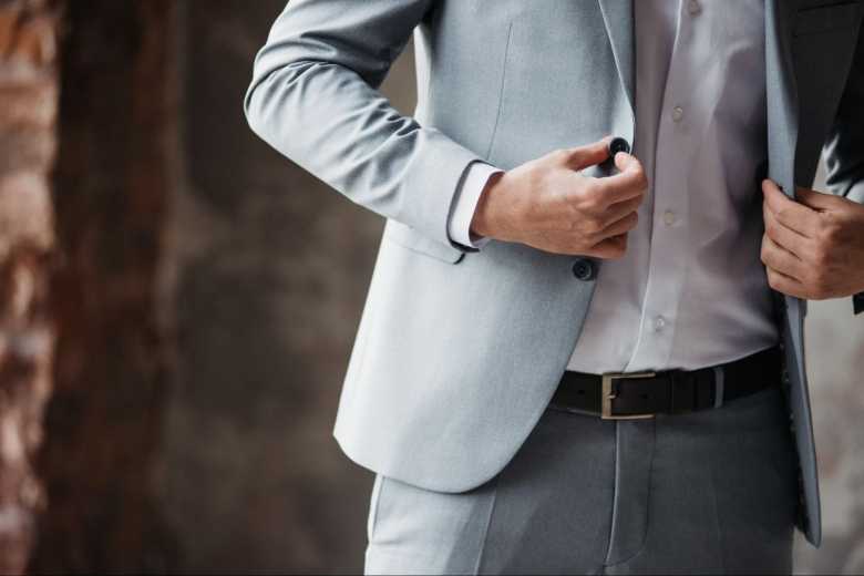 Close-up of Male Torso Butonning his Grey Suit