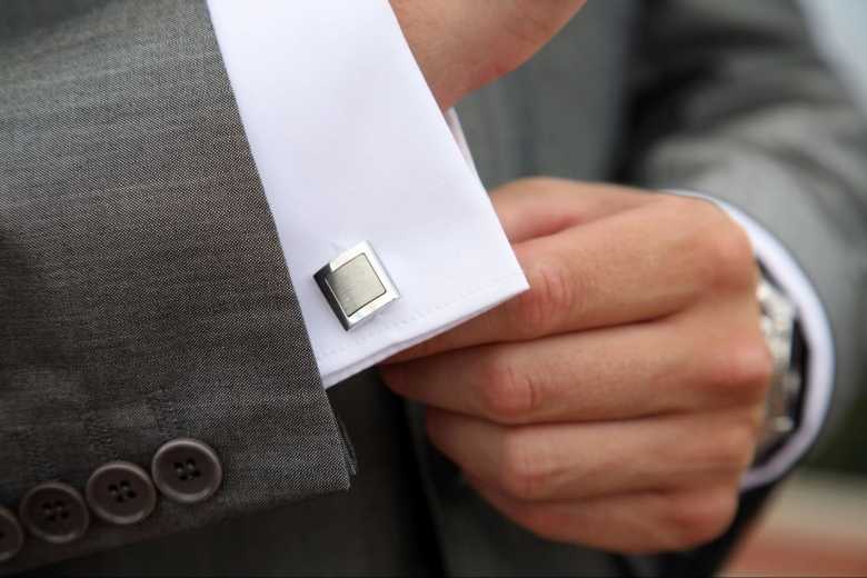 Close-up of Mans Hand Adjusting His French Cuff