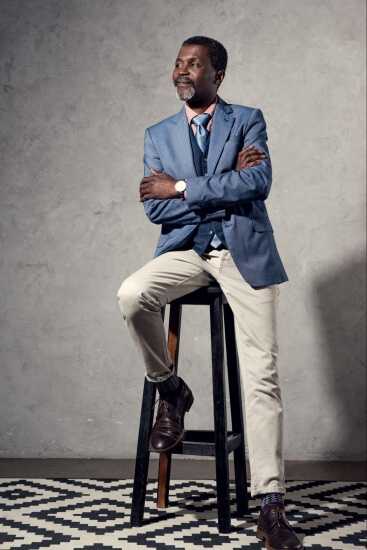 Elderly Man Wearing a Blue Suit Jacket and White Pants