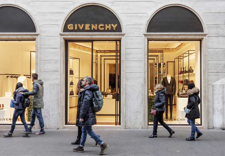 a Givenchy store and people passing by it