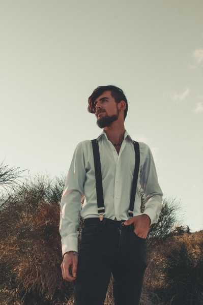 Man Wearing a White Shirt With Black Suspenders is a Natural Background