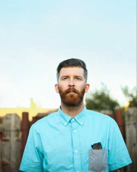 a man wearing a blue short-sleeved shirt