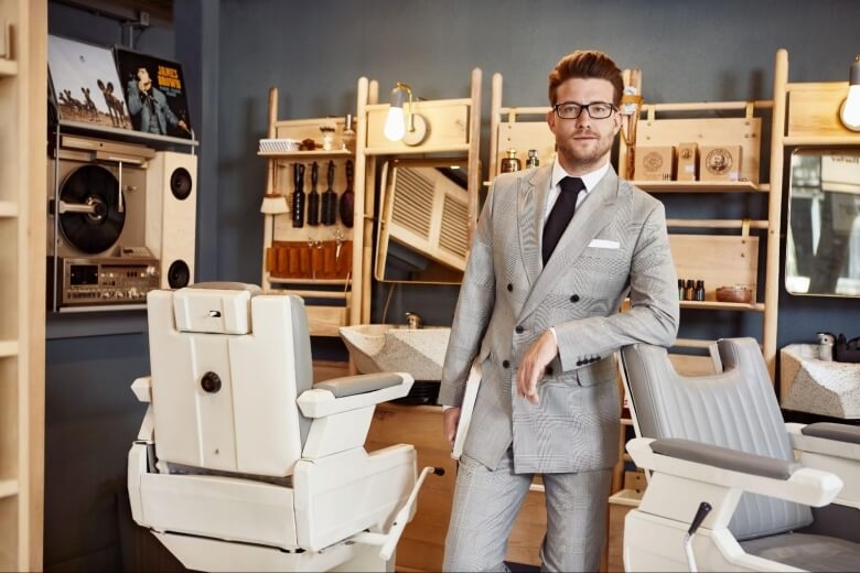 Man Wearing Light Grey Double Breasted Suit in Barber Shop