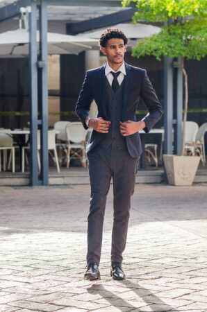 Man Wearing Suit Walking in Street