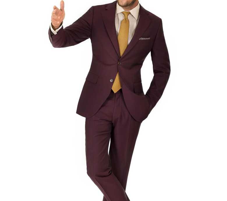 a maroon suit with a yellow tie by Oliver Wicks