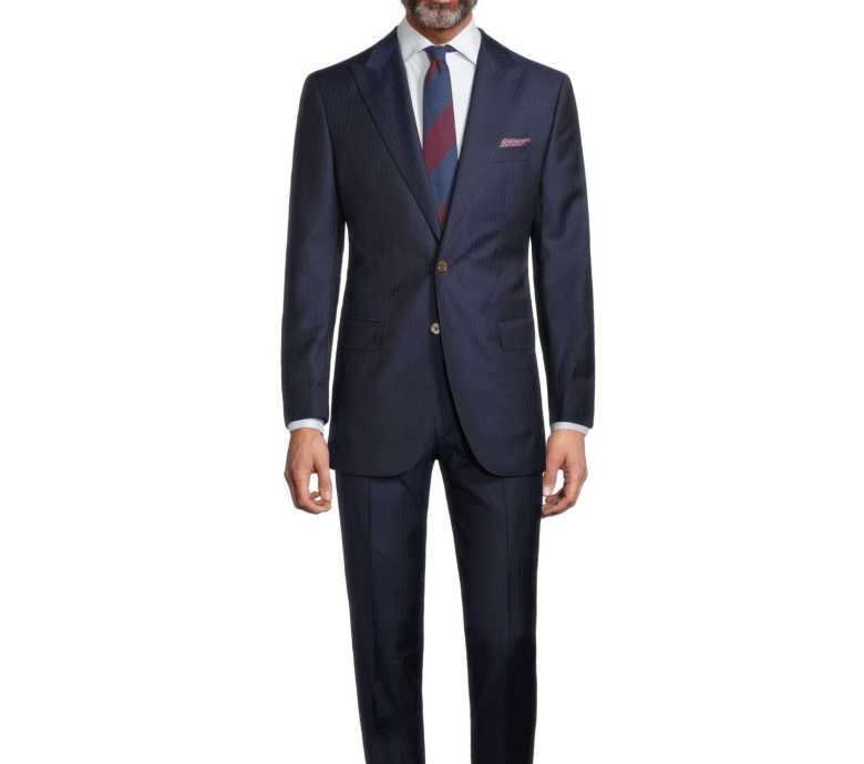 A navy blue herringbone suit by Oliver Wicks