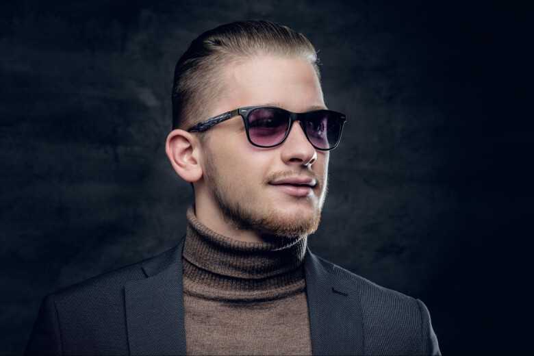 Smirking Man Wearing Sunglasses and a Turtleneck