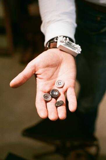 suit buttons on a tailor's palm