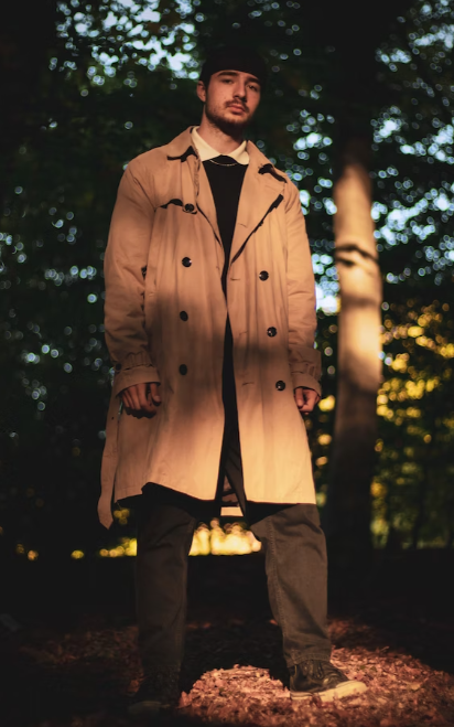 a man wearing a beige trench coat