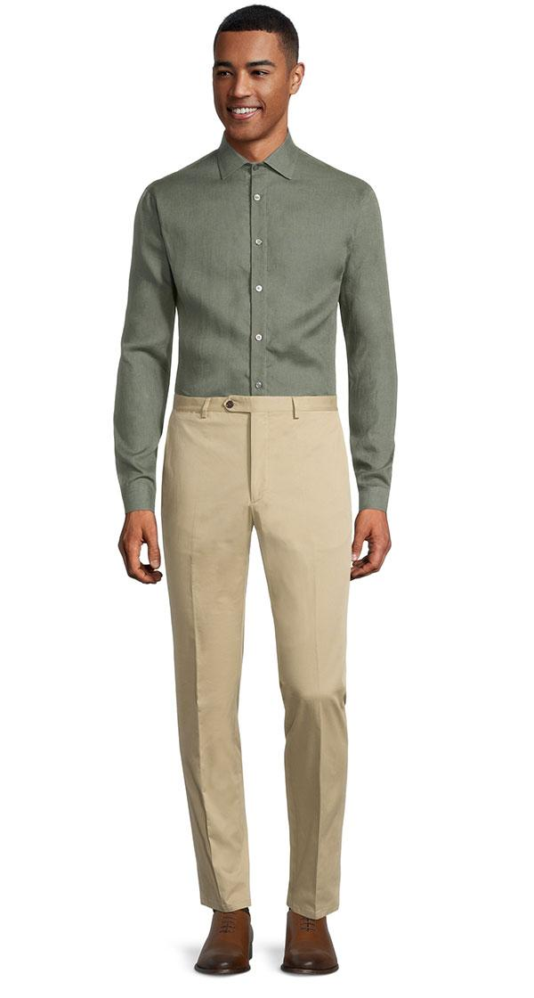 a man wearing beige chino pants by Oliver Wicks