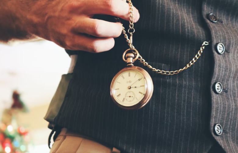 a man holding a golden pocket watch