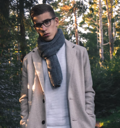 An image of a man in a light beige coat, complemented by a grey scarf